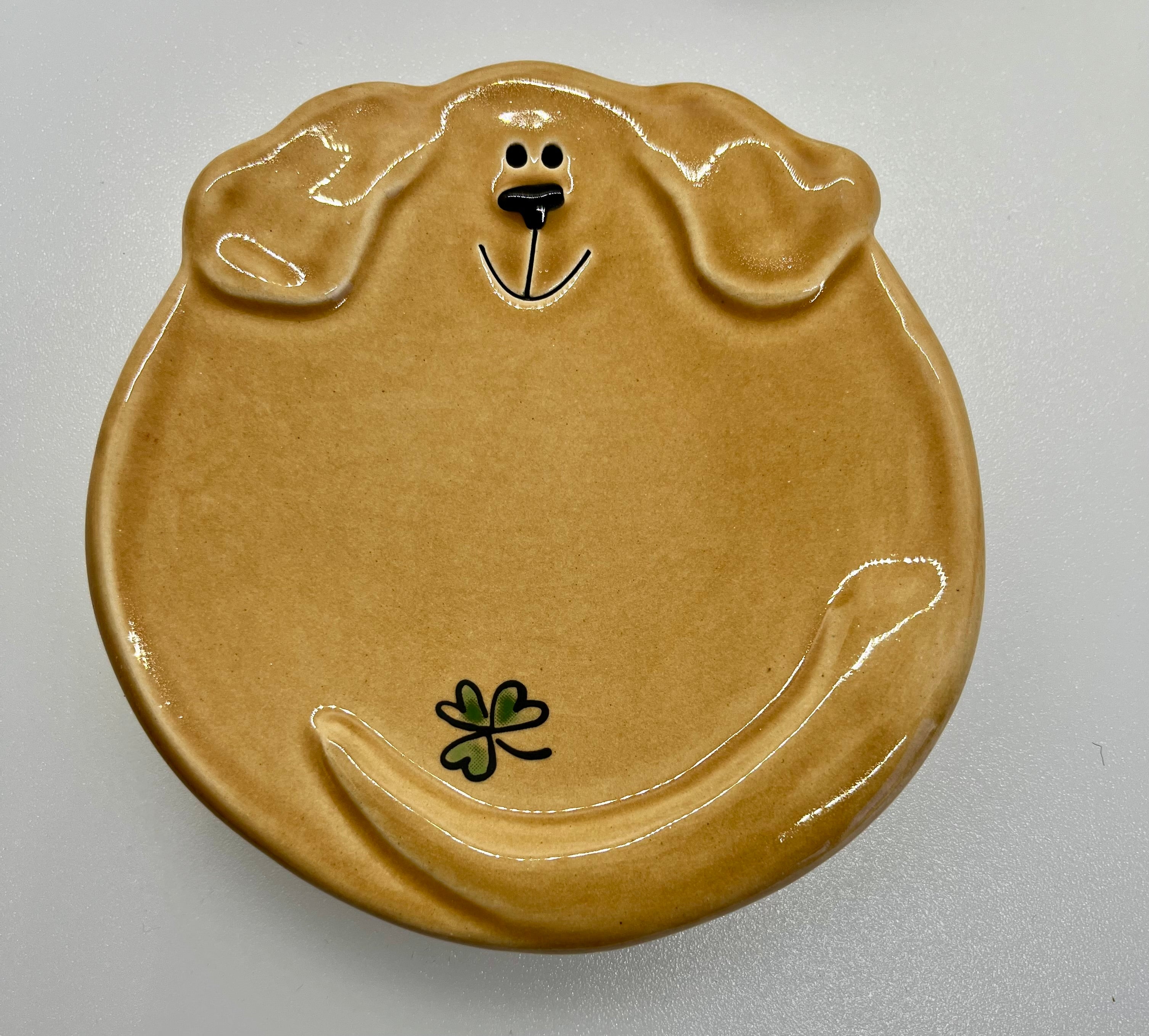 Brown ceramic plate shaped like a dog on a gray background