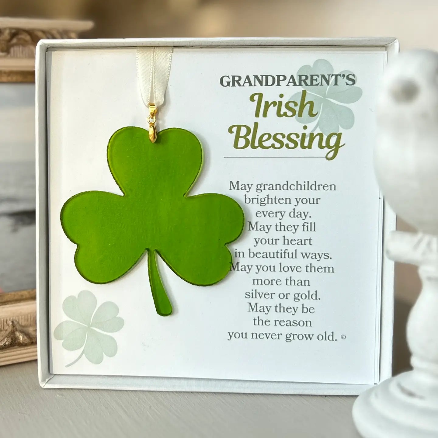 Decorative item with shamrock and text about grandparents' Irish blessing on a neutral background.