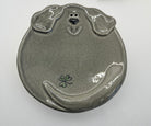 Ceramic plate shaped like a dog's face on a white background