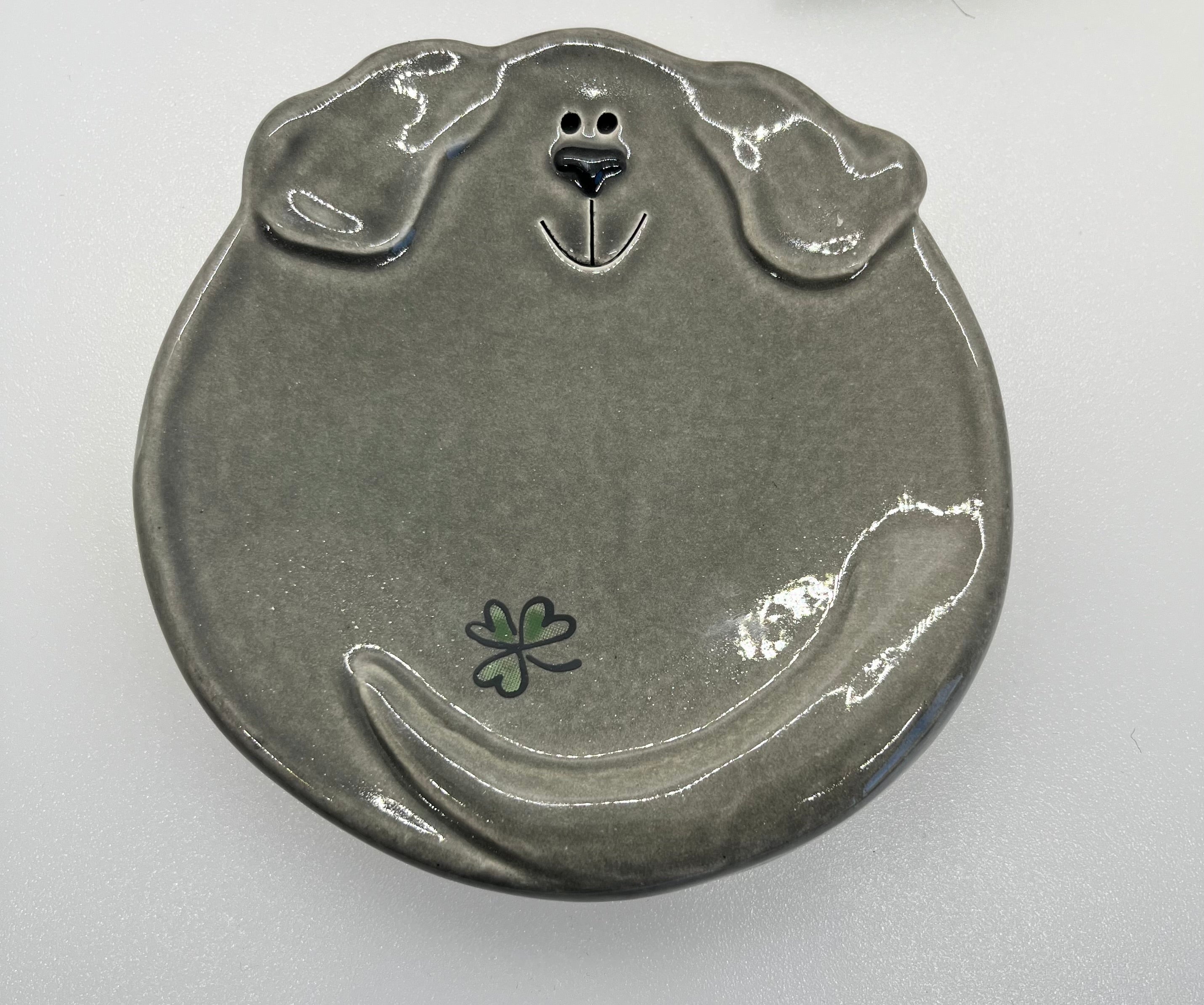 Ceramic plate shaped like a dog's face on a white background