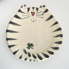 Ceramic plate designed like a cat face with black stripes on a white background