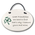 Round ceramic plaque with a shamrock and friendship quote on a white background