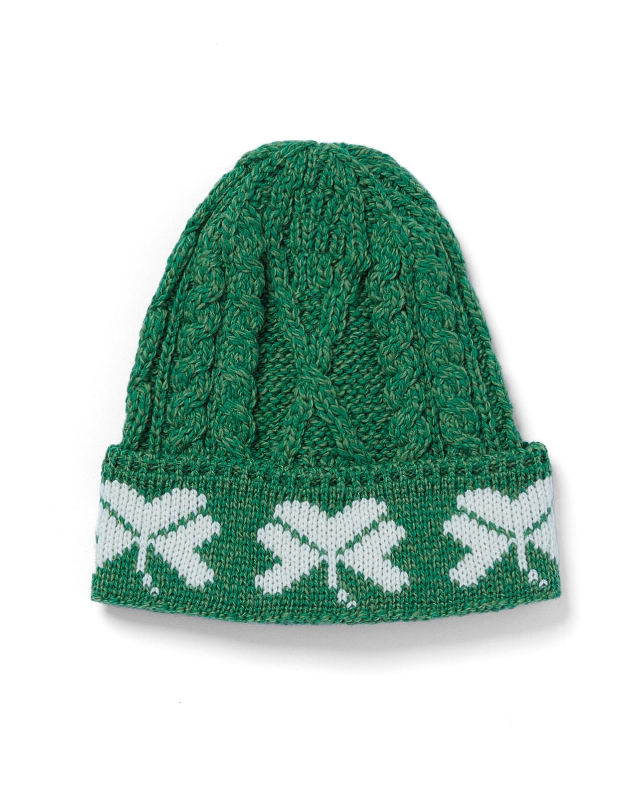 Green knitted beanie with white pattern on a white background