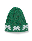 Green knitted beanie with white pattern on a white background