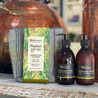Handcare gift set with two bottles and a box on a wooden surface.
