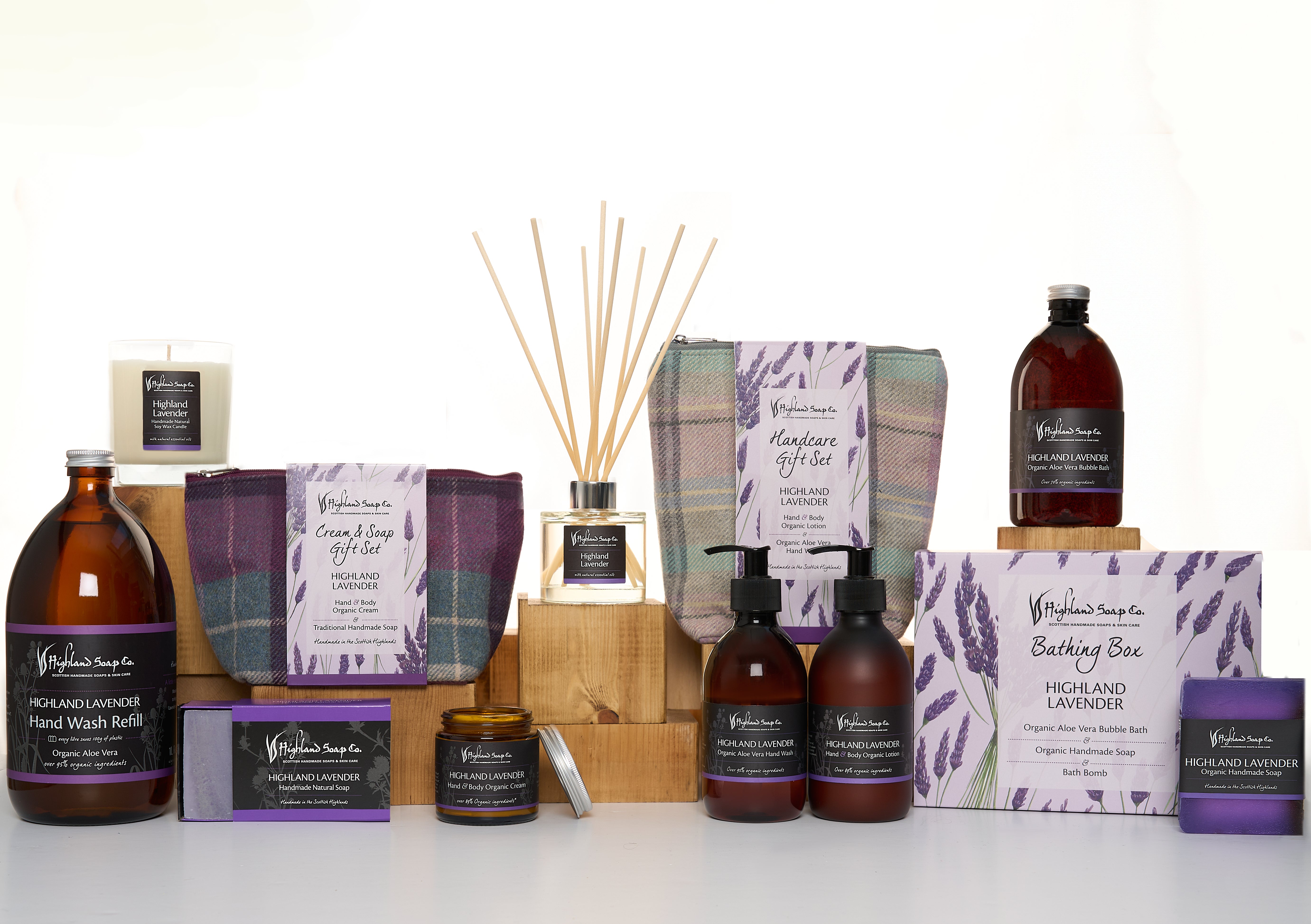 Collection of Highland Lavender products including bottles, candles, and boxes on a white background