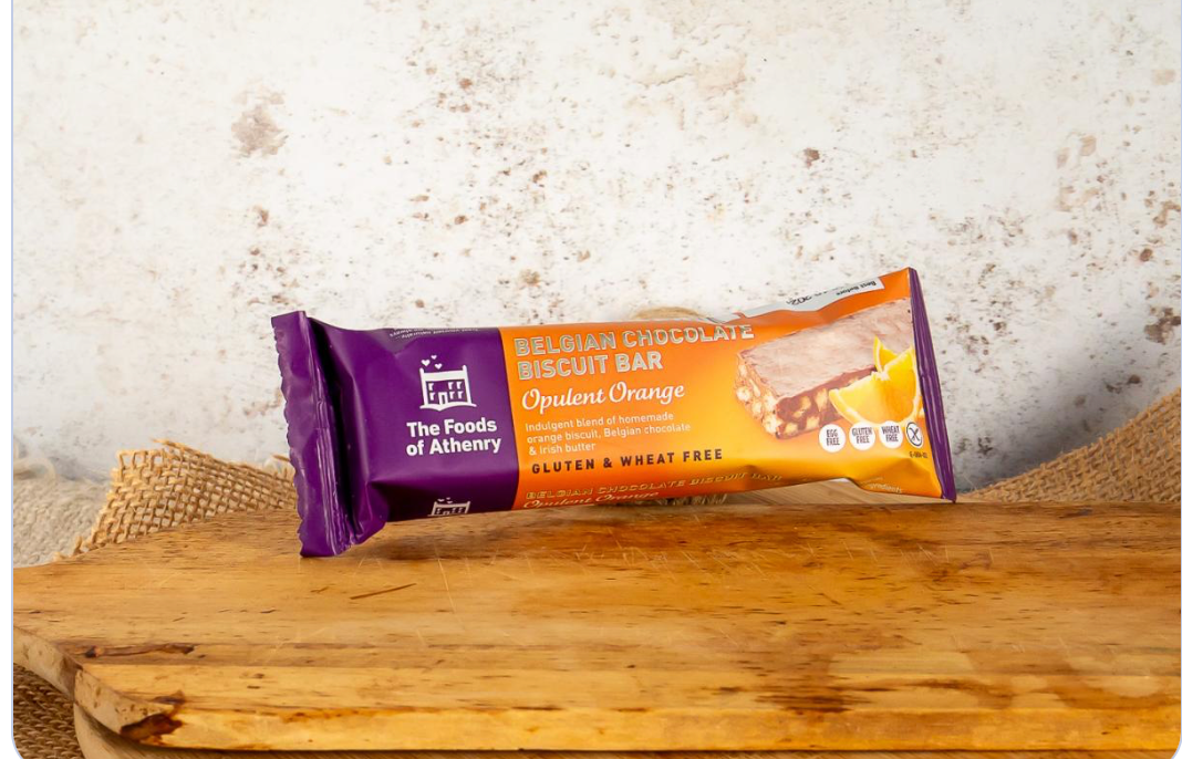 Belgian Chocolate Biscuit Bar packaging on a wooden surface with a textured background