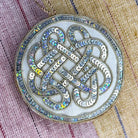 Irish linen ornament with intricate design on a fabric background
