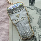 Decorative linen ornament with 'Slainte' embroidery on a vintage-style background