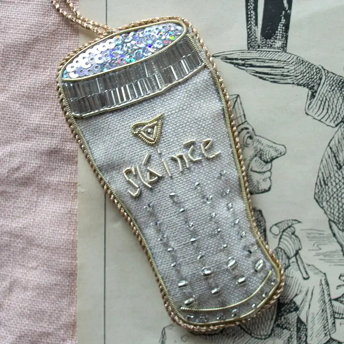 Decorative linen ornament with 'Slainte' embroidery on a vintage-style background