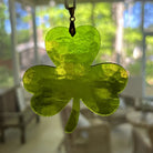 Green shamrock-shaped object hanging indoors with a blurred background
