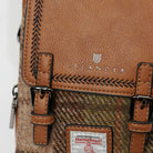 Close-up of a brown leather bag with 'Islander' branding and Harris Tweed label.