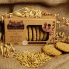 Box of Kilbeggan Irish Oat Cookies with cookies and oats on a rustic background