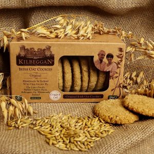 Box of Kilbeggan Irish Oat Cookies with cookies and oats on a rustic background