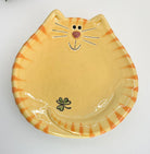 Cat-shaped ceramic plate with striped pattern on a white background