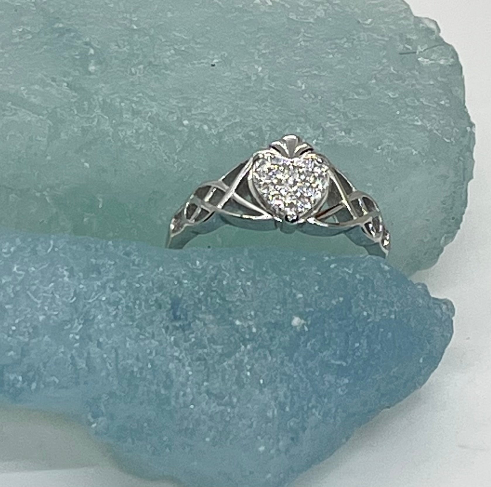 Silver ring with a heart-shaped diamond on a piece of blue stone