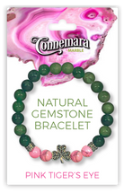 Bracelet with green and pink gemstones on a Connemara Marble packaging background