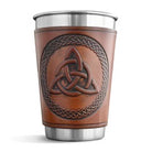 Brown leather-wrapped cup with Celtic knot design on a white background