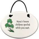Round ceramic ornament with shamrock design and text on a white background