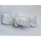 White lace baby headband with shamrock floral design on a light gray background