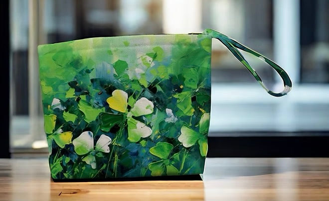 Green pouch with floral design on a wooden surface