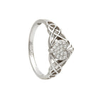 Silver claddagh ring with intricate design and small diamonds on a white background