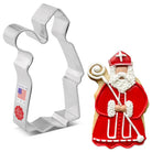 Metal cookie cutter shaped like a wavy line next to a cookie decorated like Saint Nick