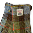 Harris Tweed fabric gloves with a visible label on a white background