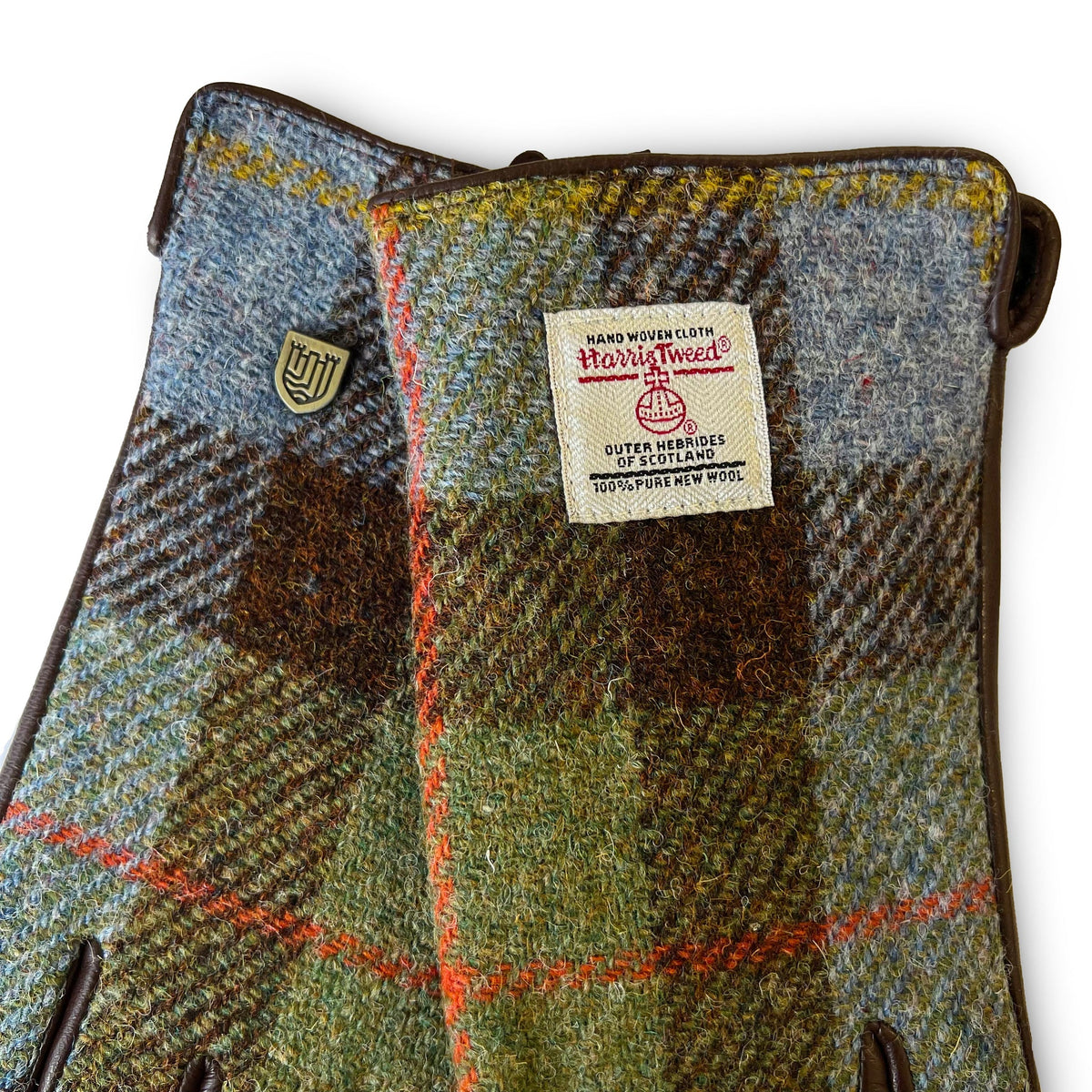 Harris Tweed fabric gloves with a visible label on a white background