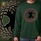 Green long-sleeve shirt with a black and gold design of the tree of life and interwoven patterns, worn by a person.