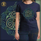 Navy blue t-shirt with green and gold Celtic knot design worn by a person, with a decorative background featuring similar patterns.